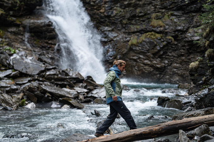 Man hiking by a waterfall