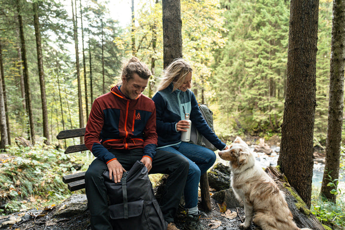 Couple resting with their dog in a forest