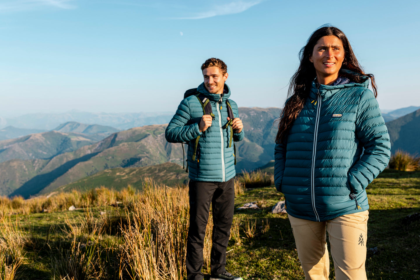 Couple wearing Natural Park insulated jackets on a mountain