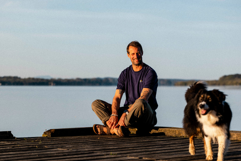 Man sitting on a dock by a body of water