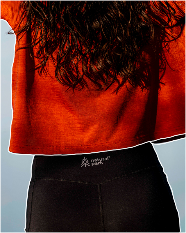 Person wearing a red shirt and black shorts