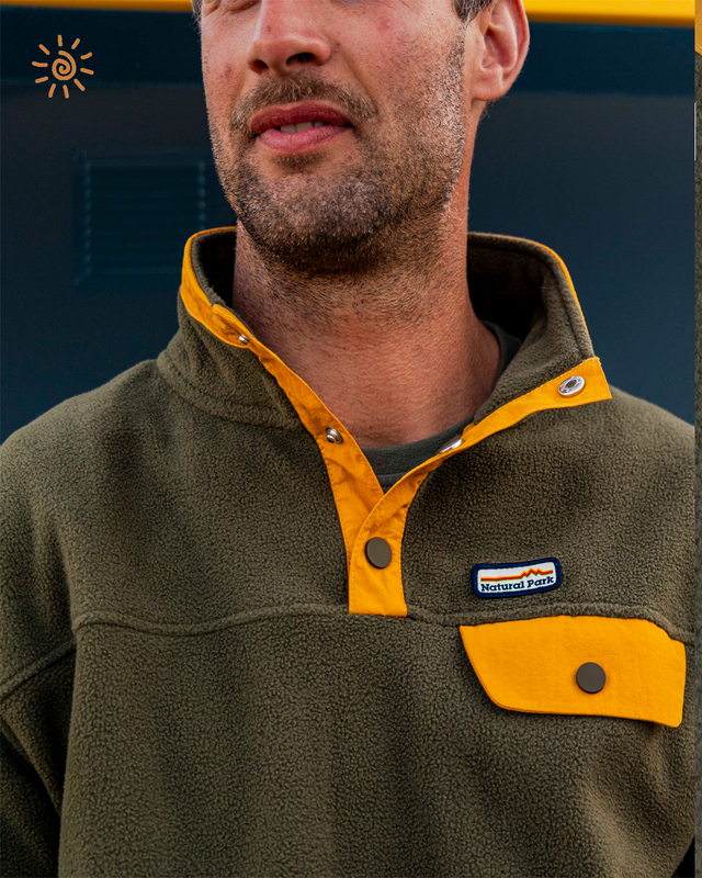 Man wearing a green and yellow fleece jacket
