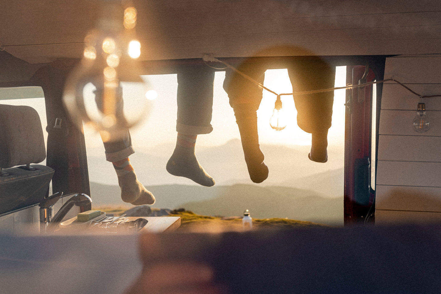 People relaxing in a van wearing Natural Park socks